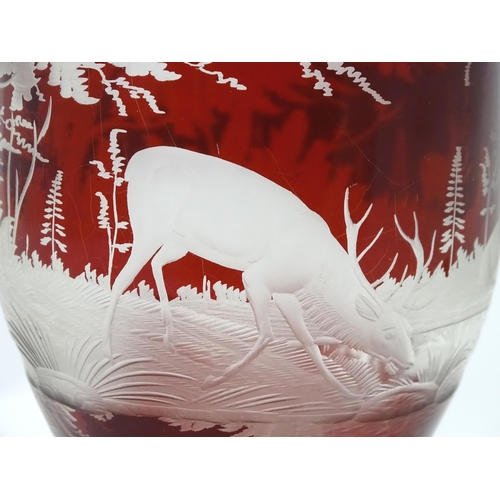 186 - A Victorian Bohemian ruby red and clear glass vase and cover with etched stag  / deer in landscape d... 