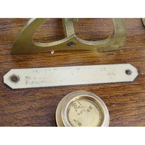 1082 - Victorian brass postal scales on a wooden base. Together with four graduated brass weights. Scales a... 