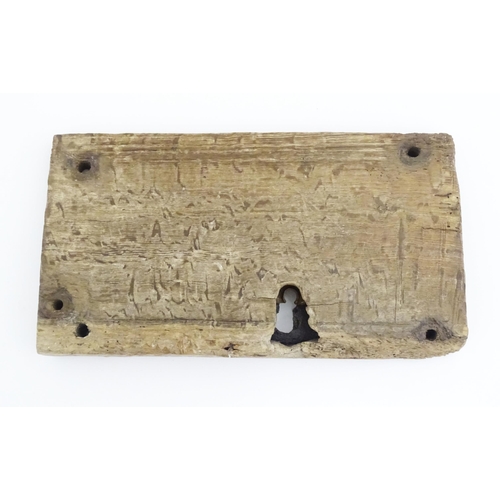 1084 - An old door lock mechanism and key mounted to a wooden panel. Panel approx. 7