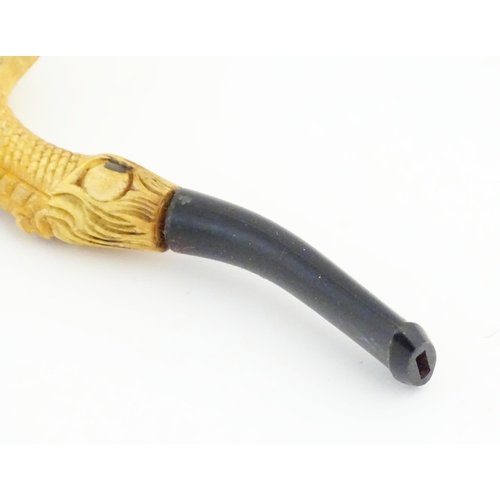 1091 - A cased Victorian carved meerschaum ladies' pipe, the stem formed as an outstretched eagle claw clut... 