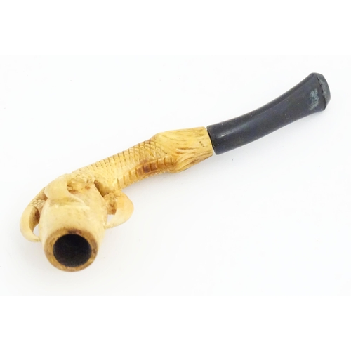 1091 - A cased Victorian carved meerschaum ladies' pipe, the stem formed as an outstretched eagle claw clut... 