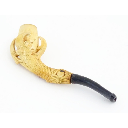 1091 - A cased Victorian carved meerschaum ladies' pipe, the stem formed as an outstretched eagle claw clut... 