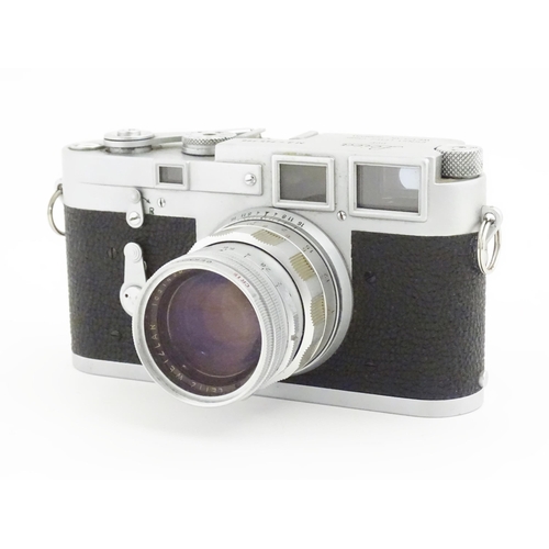 1112 - A cased Leica M3 camera with two additional lenses to include a 1:4/90mm lens fitted with a Hoya 39m... 