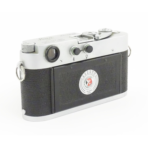 1112 - A cased Leica M3 camera with two additional lenses to include a 1:4/90mm lens fitted with a Hoya 39m... 