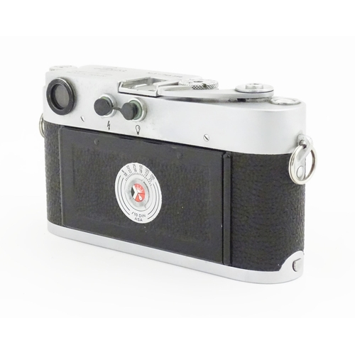 1112 - A cased Leica M3 camera with two additional lenses to include a 1:4/90mm lens fitted with a Hoya 39m... 