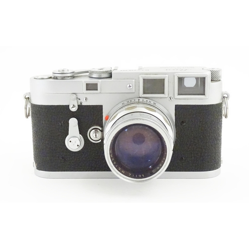 1112 - A cased Leica M3 camera with two additional lenses to include a 1:4/90mm lens fitted with a Hoya 39m... 