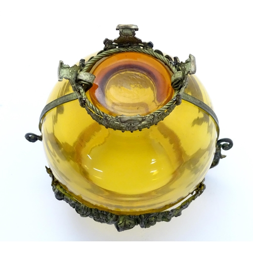 193 - A Continental amber glass vase with twin handled ormolu mount with floral swag detail. Approx 4 3/4