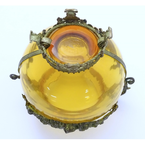 193 - A Continental amber glass vase with twin handled ormolu mount with floral swag detail. Approx 4 3/4