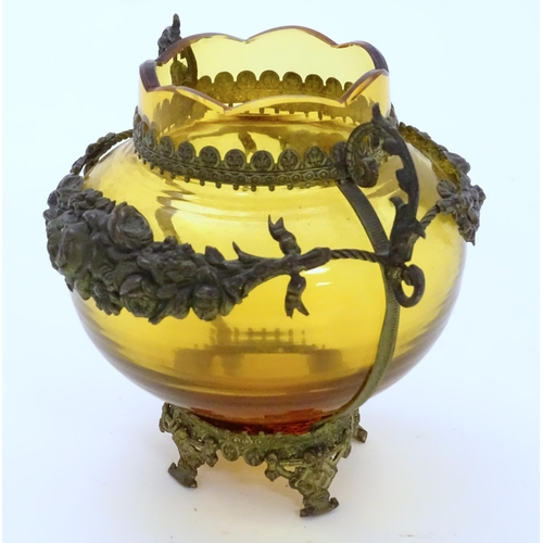 193 - A Continental amber glass vase with twin handled ormolu mount with floral swag detail. Approx 4 3/4