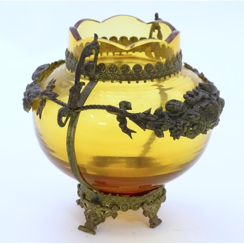 193 - A Continental amber glass vase with twin handled ormolu mount with floral swag detail. Approx 4 3/4