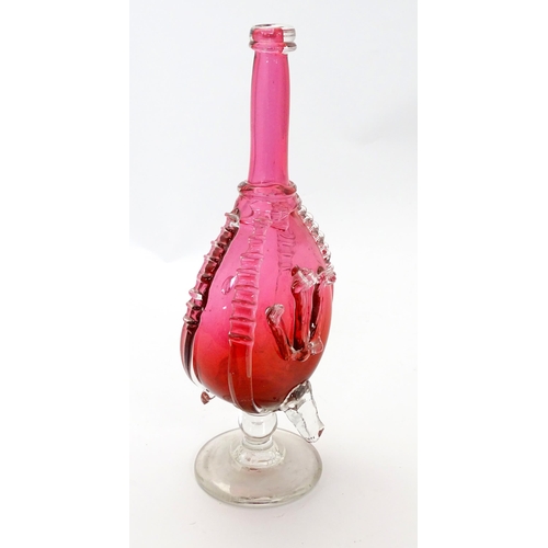 205 - A 19thC red glass bottle vase with clear pedestal foot with stylised fleurs de lys detail and coiled... 