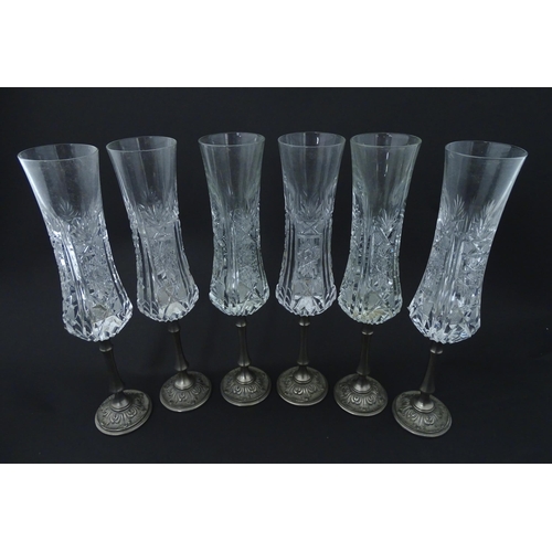 202 - A set of six Italian cut glass champagne flutes raised on  pewter stem and foot. Approx 11