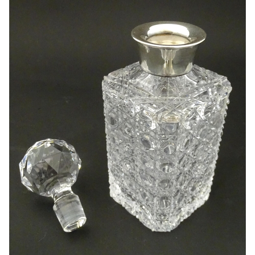 210A - A cut glass decanter with silver collar hallmarked Sheffield 1989 maker F Drury Ltd.  Approx 9 1/2