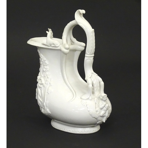 72 - A Continental white glazed jug with relief decoration depicting a wild boar hunt, the rim with goat ... 