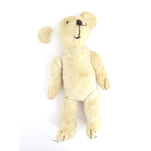 822 - Toy: A 20thC plush teddy bear with stitched nose, mouth, eyes and paws. Approx. 19 1/2