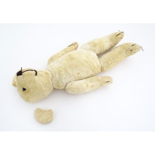 822 - Toy: A 20thC plush teddy bear with stitched nose, mouth, eyes and paws. Approx. 19 1/2