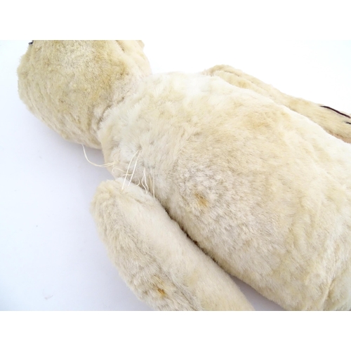 822 - Toy: A 20thC plush teddy bear with stitched nose, mouth, eyes and paws. Approx. 19 1/2