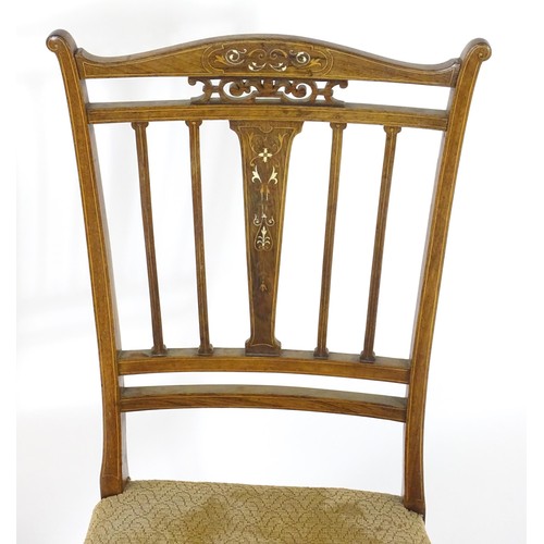 28 - Two Edwardian rosewood chairs, having inlaid and pierced backrests. 35