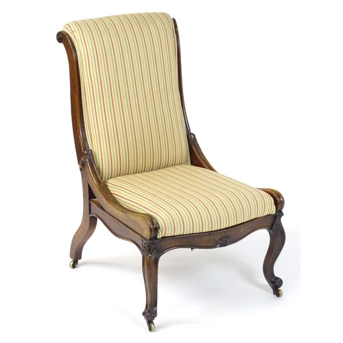 37 - A 19thC rosewood reclining chair with a scrolled back, reclining mechanism and bearing a plaque to t... 