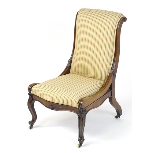 37 - A 19thC rosewood reclining chair with a scrolled back, reclining mechanism and bearing a plaque to t... 