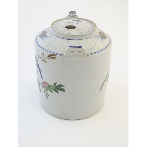 45 - A large Oriental teapot decorated with flowers, foliage and a bird, with scrolling brushwork detail.... 