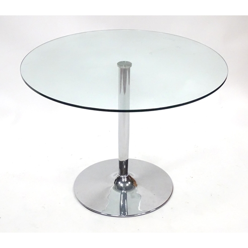 49 - A circular glass top table with a chromed metal base. Approx. 40