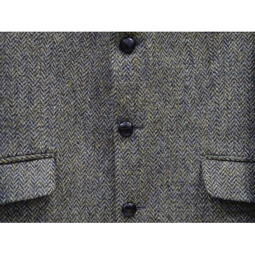 80 - A Harris Tweed hacking jacket by Gurtex, with three buttons to front and single vent to rear, measur... 