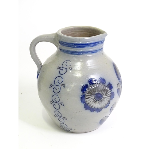 95 - A quantity of German salt glazed stoneware items to include a wine jug / ewer with blue painted deta... 