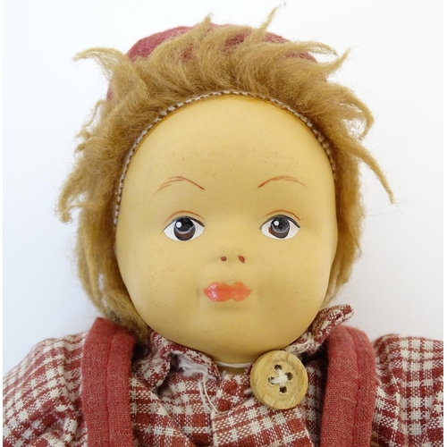 96 - Toys: Two Scandinavian / Norwegian dolls with bisque heads, the girl with a knitted hat, scarf and j... 