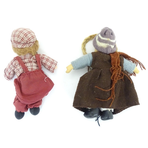 96 - Toys: Two Scandinavian / Norwegian dolls with bisque heads, the girl with a knitted hat, scarf and j... 