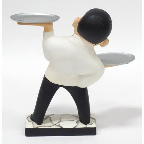 143 - A small novelty dumb waiter figure formed as a waiter holding two dishes. Approx 21 1/2