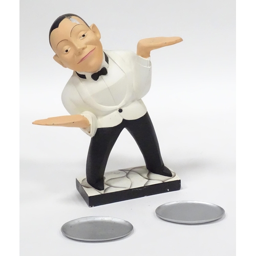 143 - A small novelty dumb waiter figure formed as a waiter holding two dishes. Approx 21 1/2