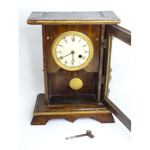 144 - A mantel clock with white enamel dial having Roman numerals and winding hole at four.