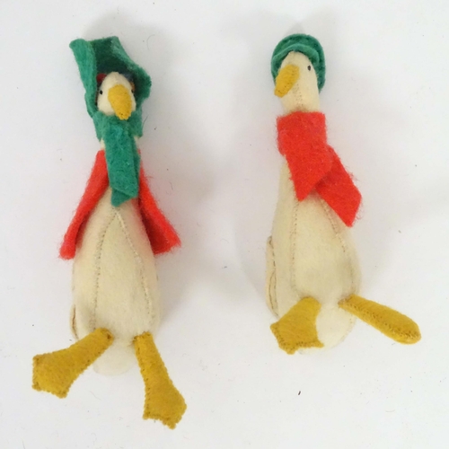 176 - Toys: Three felt animals comprising a duck wearing a hat and scarf, a duck wearing a bonnet based on... 