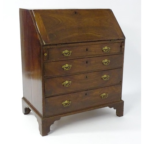 67 - A mid 18thC mahogany bureau with a fall front above four long drawers with shaped back plates and br... 