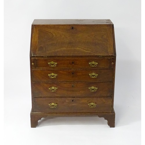 67 - A mid 18thC mahogany bureau with a fall front above four long drawers with shaped back plates and br... 