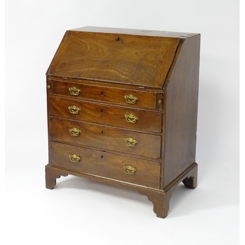 67 - A mid 18thC mahogany bureau with a fall front above four long drawers with shaped back plates and br... 