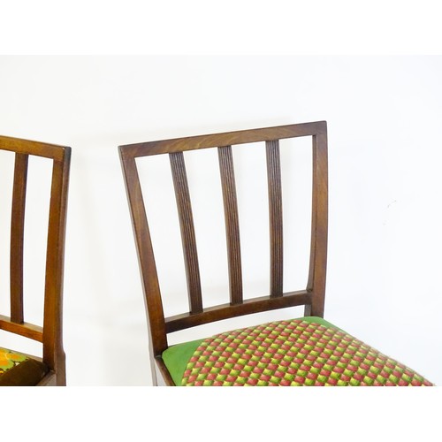54 - A pair of late 19thC / early 20thC side chairs with reeded back rails and drop in seats above taperi... 