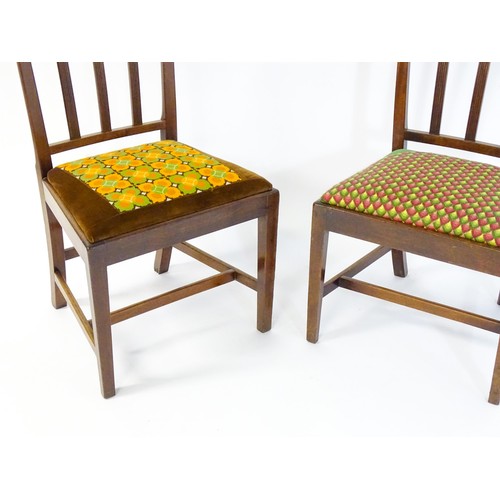 54 - A pair of late 19thC / early 20thC side chairs with reeded back rails and drop in seats above taperi... 