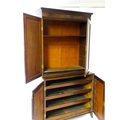 82 - A late Georgian mahogany linen press with a moulded cornice above two sections with panelled doors h... 