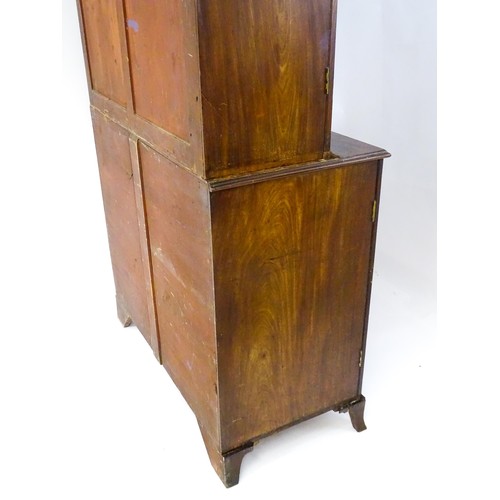 82 - A late Georgian mahogany linen press with a moulded cornice above two sections with panelled doors h... 