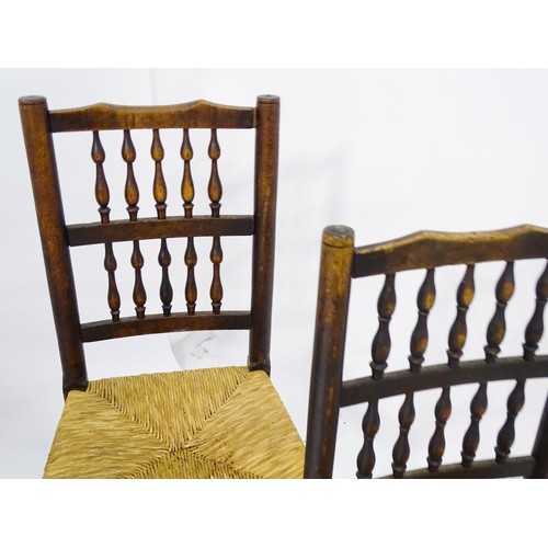 229 - A group of four (2+2) 19thC spindle back chairs with envelope rush seats. 23