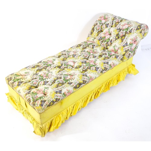 238 - An early / mid 20thC chaise longue with deep buttoned floral upholstery and raised on four castors. ... 