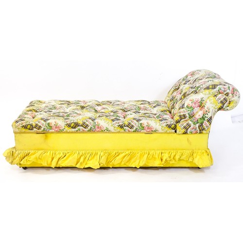 238 - An early / mid 20thC chaise longue with deep buttoned floral upholstery and raised on four castors. ... 