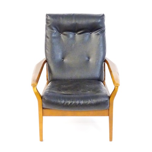 249 - A Cintique retro armchair with deep button upholstery, tapering arms and raised on four tapering leg... 