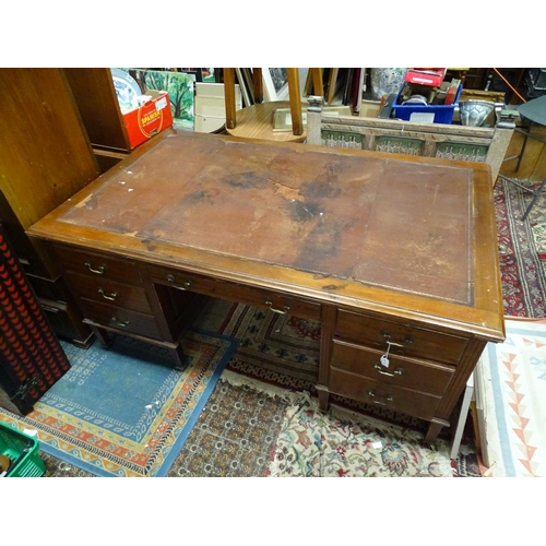 263 - Large early 20thC mahogany desk with leather insert to top and  standing on 8 legs with brass caster... 