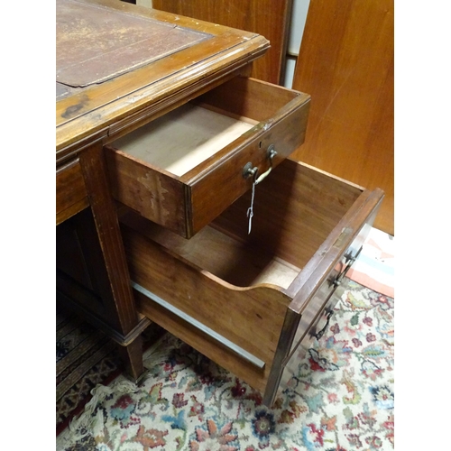 263 - Large early 20thC mahogany desk with leather insert to top and  standing on 8 legs with brass caster... 