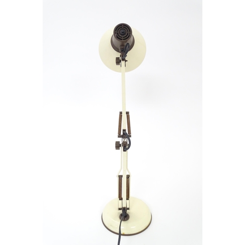 292 - An adjustable desk lamp in cream and brown livery in the Anglepoise style, marked under Patent Pendi... 