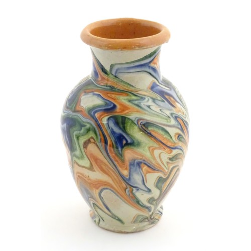 302 - A terracotta vase with agate ware / marbled glaze. Approx. 6 3/4