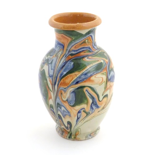 302 - A terracotta vase with agate ware / marbled glaze. Approx. 6 3/4